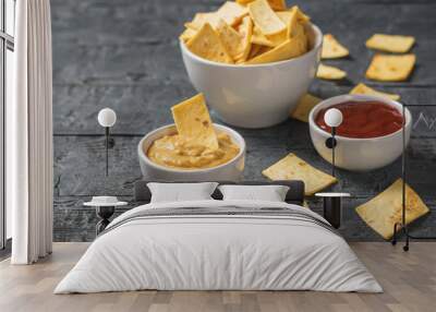 Bowl of Mexican tortilla chips with mustard and chili sauce. Wall mural