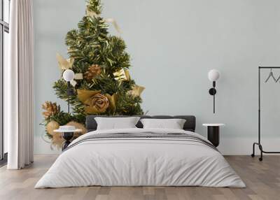 Christmas tree in the sacking on a wooden table. Wall mural