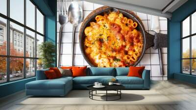 Baked macaroni and cheese with fresh tomato sauce served on hot pan Wall mural