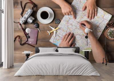 young couple planning vacation trip with map. top view. Wall mural