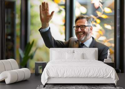 A happy businessman celebrating a successful deal with a high-five in a modern office Wall mural