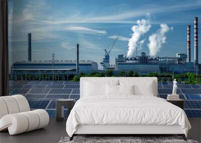 A rooftop covered with solar panels on a large factory, with industrial activity and manufacturing visible below, reflecting a green energy strategy in action Wall mural