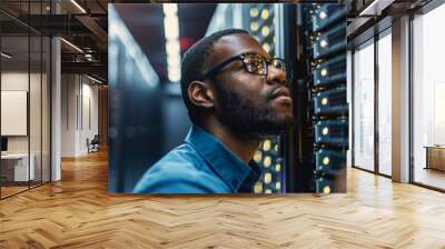 An IT specialist working on computer servers in a data center, symbolizing technology expertise and digital infrastructure Wall mural