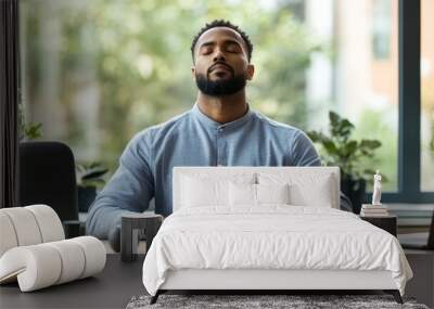 Entrepreneur engaging in deep breathing exercises at a home office desk, using mindfulness techniques to combat work stress. Wall mural