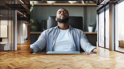 Entrepreneur engaging in deep breathing exercises at a home office desk combating work stress with mindfulness techniques Wall mural