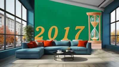 gold wooden font year 2017 and sandglass on wood table Wall mural