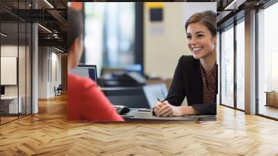 Professional customer service representative engaging in a positive client interaction with a friendly smile and attentive listening in a modern office environment Wall mural