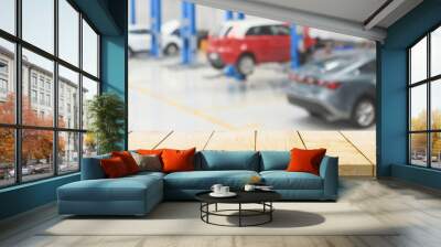 Empty wood table top with car service centre auto repair workshop blurred background Wall mural