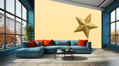 golden Christmas star glitter sticker isolated on yellow background Wall mural