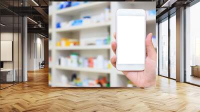 woman using mobile smartphone in the pharmacy Wall mural