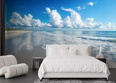 a sandy beach with waves coming in to the shore Wall mural