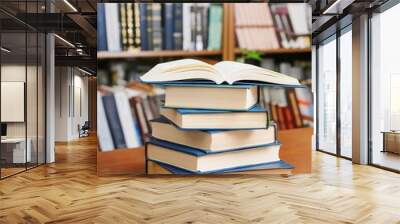 stack of books on a library table Wall mural