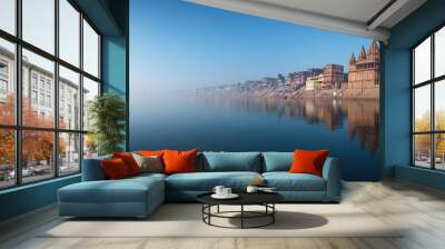 A panoramic view of the Ganges River in Varanasi, with ghats and temples reflecting in the water, devoid of any people Wall mural