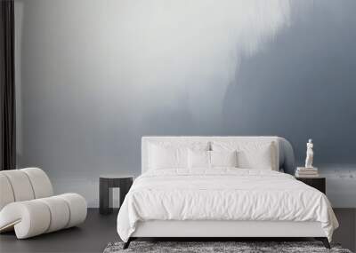 A polar bear makes its way across a vast snowy landscape, the scene serene and peaceful as the bear stands out against the white background. Wall mural