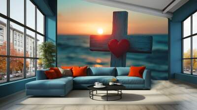 A wooden cross standing tall against the backdrop of the sea at sunrise, with a red heart hanging from it, symbolizing love and sacrifice. Wall mural