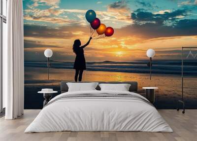 Woman holding flying balloons on the beach at sunset, silhouette capturing joy and happiness. Perfect for inspirational themes and celebratory visuals. Wall mural