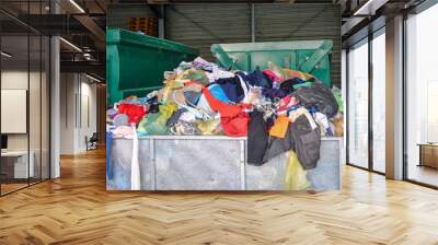 Used clothes at recycling utility. Circular economy concept. Wall mural