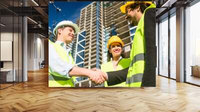 Architects and foreman in meeting at construction site Wall mural