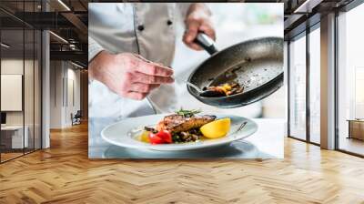 Chef finishing food in his restaurant kitchen Wall mural