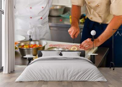 Chefs preparing fish in restaurant or hotel kitchen Wall mural