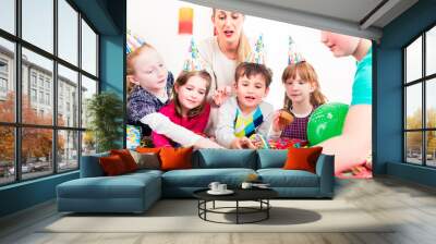 Children at birthday party with muffins and cake Wall mural