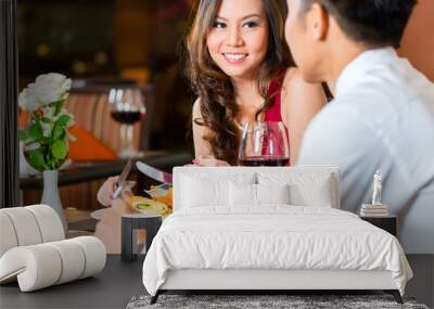 chinese couple having romantic dinner in fancy restaurant Wall mural