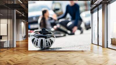 Close-up of a bicycling helmet fallen down on the ground after accidental collision between bicycle and a 4x4 car Wall mural