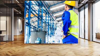 Industrial worker in factory with tools Wall mural