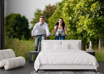 man and woman cycling in summer Wall mural