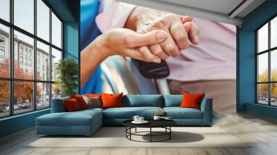 Nurse consoling a senior woman in the nursing home holding her hand Wall mural