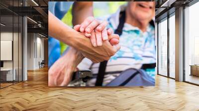 Nurse consoling senior woman holding her hand Wall mural