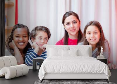 Smiling woman sitting with children Wall mural