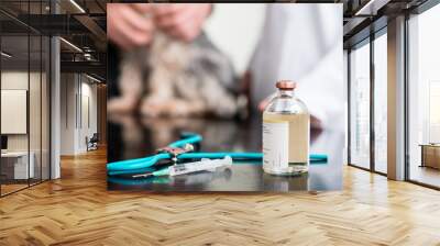 Syringe, injection solution bottle and doctor instrument on table Wall mural