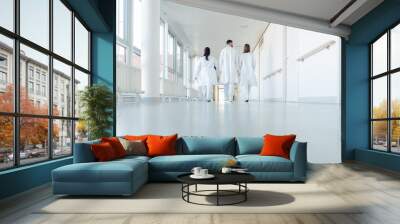 Three doctors walking down a corridor in hospital Wall mural