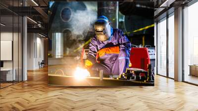 Welder working in industrial factory Wall mural