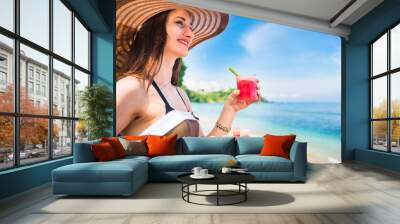 woman at tropical beach eating fruit for breakfast Wall mural