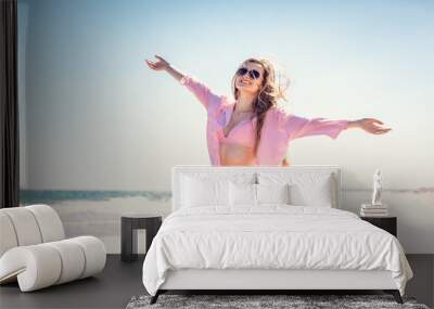 Woman enjoying the freedom of a beach vacation Wall mural