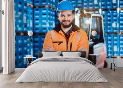 Worker in a forwarding company with his forklift Wall mural