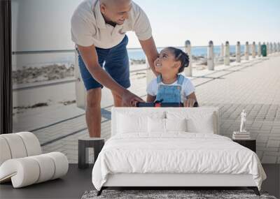 Father, girl child and tricycle at park, learning and happy in ocean sunshine on family vacation. Dad, daughter and happiness by sea promenade, teaching and smile on seaside holiday in San Francisco Wall mural