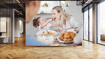 Happy family, mother and child eating chicken and vegetables in a healthy meal for dinner in Germany, Berlin. Food, nutrition and young girl feeding her hungry mom lunch at a home dining room table Wall mural