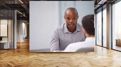 passionate about what he does. a manager sitting and having a discussion with an employee. Wall mural