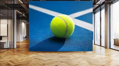 Tennis ball on blue tennis court. the concept of a sporty lifestyle.
 Wall mural