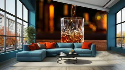 Whiskey is poured into glass. Glass of whiskey on bar counter in restaurant
 Wall mural