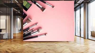 Creative concept beauty fashion photo of cosmetic product make up brushes kit on pink background. Wall mural