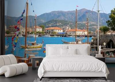 Charming harbor with sailing boats and picturesque buildings for travel and maritime concepts Wall mural