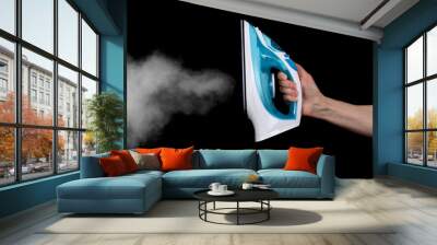 Modern electric iron with steam isolated on black Wall mural