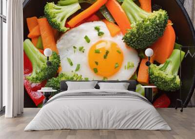 Egg and vegetable stir-fry with bell peppers, broccoli, carrots in black cast-iron skillet, vegetarian, healthy food, nutrition, lifestyle, flat lay. Wall mural