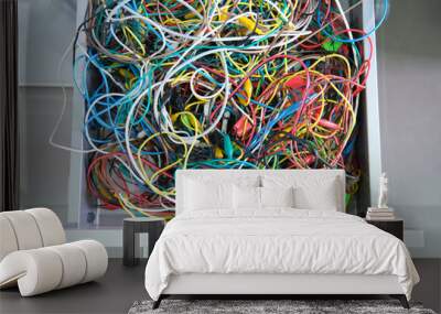 Disorganized colorful cables on a drawer. Messy wires. Wall mural