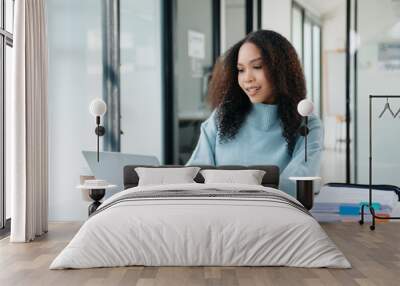 Portrait of female office businesswoman startup daydreaming about her work, startup and working with laptop on office Wall mural