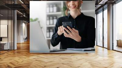 Woman hand using smart phone, tablet payments and holding credit card online shopping, omni channel, digital tablet docking keyboard computer at office in sun light. Wall mural